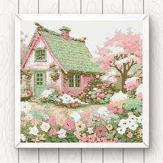 a cross stitch pattern of a cottage with flowers and trees in the foreground, on a wooden background