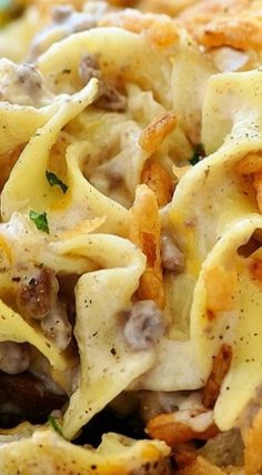 closeup of pasta with cheese and mushrooms on it in a dish that is ready to be eaten