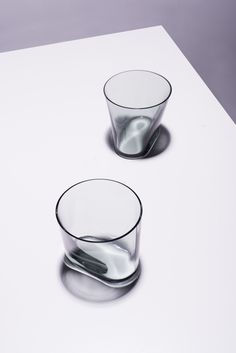 two glasses sitting on top of a white table