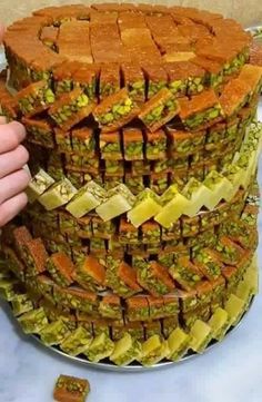 a large cake made to look like it is stacked on top of each other with pieces cut out