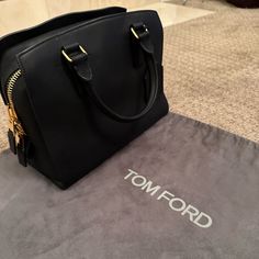 Tom Ford Nwt Black Leather With Gold Detail Never Been Used Pristine Condition Black Leather Day Bag. I Can Even Send You The Receipt. Tags Attached Comes With Dust Bag As Well. This Was A Very Rare Bag That Has Never Been Used Measurements Length 13 Inches Height 10 Inches Width 6 Inches. High-end Formal Bag With Zipper Closure, Formal Tan Bag With Zipper Closure, Tom Ford Bags, Tom Ford Bag, Day Bag, Gold Details, Very Rare, Tom Ford, 6 Inches