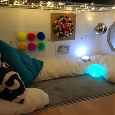 a bed with pillows and lights on the headboard