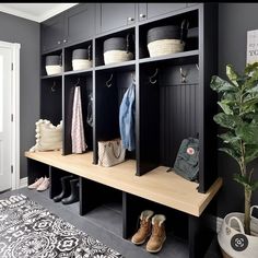 the entryway is decorated in black and white with lots of storage space for shoes