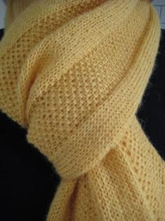 a yellow knitted scarf on a mannequin