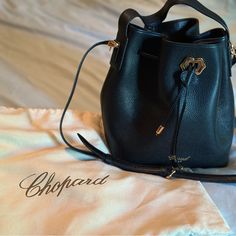 Brand New. Never Used. All Leather Black Chopard Bucket Bag. Comes With Dust Cover High-end Evening Bucket Bag, Luxury Black Bucket Bag With Branded Hardware, Elegant Bucket Bag With Palladium Hardware, Elegant Bucket-style Shoulder Bag With Palladium Hardware, Elegant Bucket Shoulder Bag With Palladium Hardware, Luxury Bucket Bag For Formal Occasions, Elegant Shoulder Bucket Bag With Palladium Hardware, Luxury Black Bucket Bag With Gold-tone Hardware, Luxury Bucket Bag With Detachable Strap