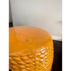 an orange stool is sitting on the floor