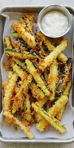 fried zucchini sticks with ranch dressing in a tray