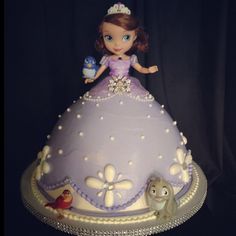 there is a cake that looks like a princess on the table