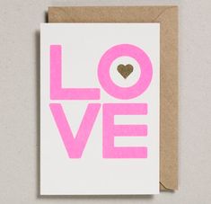 a card with the word love written in pink on it