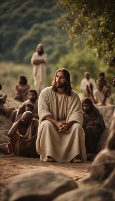 jesus sitting on the ground surrounded by people