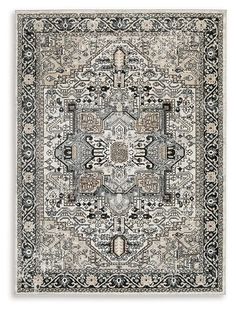 a rug with an intricate design on the front and back side, in grey tones