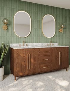 a bathroom with two sinks and mirrors on the wall