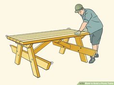 a man working on a wooden picnic table