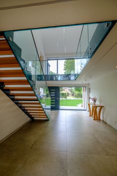 Expansive double height glass to the entrance of a modern replacement dwelling Front Door Systems, Glass Entrance, Modern Front Porches, Modern Entrance, Double Height, Entrance Door Design, Minimal Lighting, Transom Windows