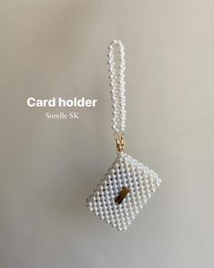 the card holder is made out of pearls