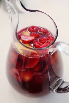 a pitcher filled with liquid sitting on top of a table