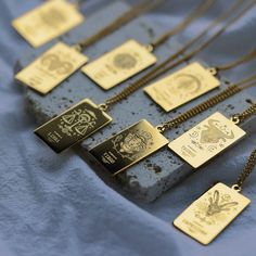 a group of necklaces sitting on top of a blue cloth covered table next to each other