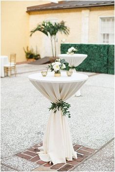 an image of a table with flowers and greenery on it for a social post