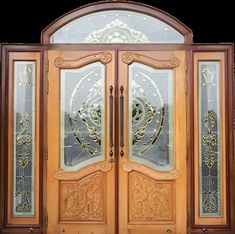 an ornate wooden double door with glass panels