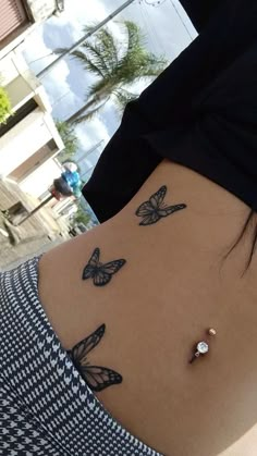 the back of a woman's stomach with butterflies on it