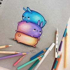 a drawing of two cartoon characters hugging each other with colored pencils next to them