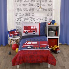 a child's bedroom with a fire truck bedding set and toy trucks on the wall