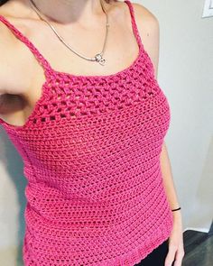 a woman wearing a pink crocheted tank top