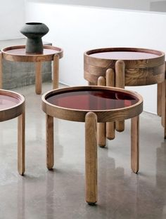 three wooden tables sitting on top of a cement floor