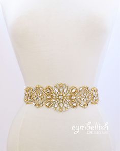 "EYMbellish Bridal Belts are the highest quality crystal rhinestone belts, perfect as a wedding belt or bridesmaids belt. Stunning Gold Bridal Belt featuring gold beading, clear crystal rhinestones a satin sash in the color of your choice. Absolutely perfect addition to dress up any gown with some gorgeous bling. Rhinestones are clear in a gold setting. This applique is very unique and features a fabric mesh backing, and gold metallic embroidery work. The intricate design is gorgeous and add dim Gold Embellished Wedding Sash, Gold Embellished Sashes For Wedding, Gold Crystal Bridal Belt For Party, Gold Crystal Bridal Belt For Wedding, Elegant Gold Bridal Belt With Rhinestones, Elegant Gold Bridal Belt With Sashes, Elegant Gold Bedazzled Jewelry, Gold Crystal Bedazzled Jewelry, Bridal Image