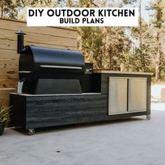 an outdoor bbq grill sitting on top of a cement floor next to a wooden fence