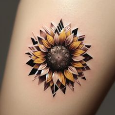 a sunflower tattoo on the back of a woman's thigh with geometric shapes