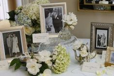 a table with pictures and flowers on it