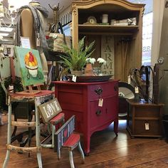 a room filled with lots of furniture and decor on top of hard wood flooring