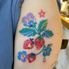 a woman's arm with flowers and hearts painted on the back of her body