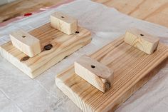 three pieces of wood sitting on top of a table