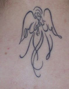 an angel tattoo on the back of a woman