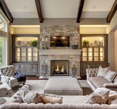 a living room filled with furniture and a fire place in the middle of it's walls