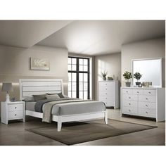 a white bed sitting in a bedroom next to a dresser and mirror on top of a wooden floor