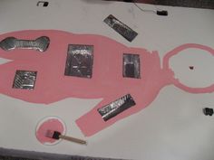 a table topped with pink paper cut outs and scissors