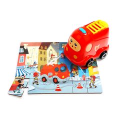 a red toy bus on top of a puzzle