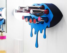 This wall mounted lipstick organizer is very easy to hang on your wall and big enough to fit 10 of your favorite lipsticks. The makeup organizer is available in many glittering colors like red, gold, blue, green, silver, light pink, dark pink, or black.It has in a very unique dripping-lip shape, adding a stunning 3-dimensional wall art effect to your room you cannot find anywhere else.An exciting and unique gift idea!Your new organizer:♡ Will grip your makeup so it stays in place.♡ Can be given Wall Mounted Makeup Organizer, Hanging Makeup Organizer, Wooden Makeup Organizer, Lipstick Products, Functional Wall Art, Perfect Red Lipstick, Green Lipstick, Green Lips, Lipstick Organizer