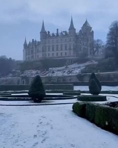 an old castle is seen in the distance on a snowy day