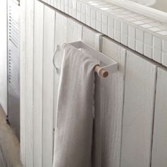 a towel rack in the corner of a bathroom