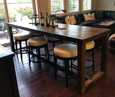 a large wooden table sitting in the middle of a living room