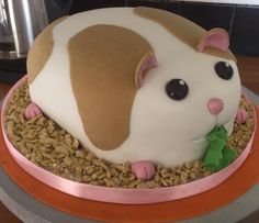 a cake shaped like a hamster on top of some food