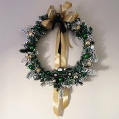 a christmas wreath hanging on the wall with a car in it and decorations around it