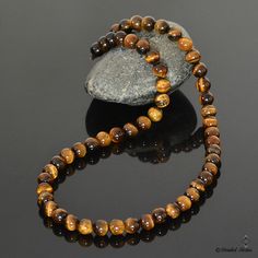 "This handmade men's necklace is made with natural Tigers Eye stone beads. Simple yet sophisticated, this beaded necklace is great as a gift for dad, a birthday gift for him or as a good luck amulet (since Tiger's Eye is said to bring good luck and protection to its wearer). This Tigers Eye necklace for men looks great both with formal or casual attire. Tiger's Eye is believed to attract and maintain wealth, enhance good luck and bring protection to its wearer. It is said to be a balancing and g Brown Single Strand Beads For Gift, Brown Single Strand Beads As Gift, Brown Polished Beads Necklace As A Gift, Brown Polished Beads Necklace For Gift, Brown 8mm Beads Necklace For Gift, Brown Necklace With Round Beads For Gift, Brown Beaded Necklaces As Gifts, Brown Gemstone Beaded Necklaces As Gift, Brown Gemstone Beads For Gifts