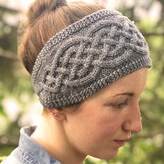 a woman wearing a knitted headband in grey