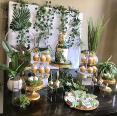 a table topped with lots of desserts and plants