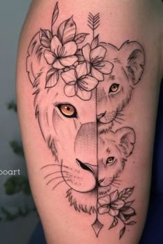 a woman's thigh with a lion and flowers on it